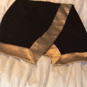 Black lined mini skirt with gold trimmings